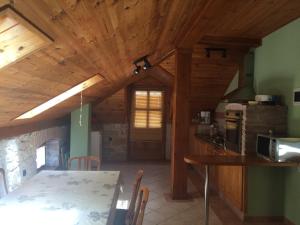 a kitchen and dining room with a wooden ceiling at PRST 1 in Ugljan