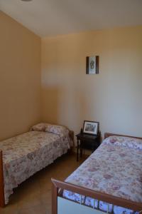 Postel nebo postele na pokoji v ubytování Villa Lu Noto