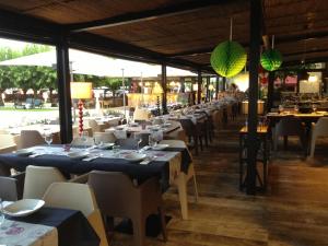 a row of tables and chairs in a restaurant at Hostal SolFina in Palafolls