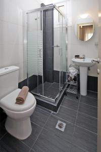 a bathroom with a shower and a toilet and a sink at Mr&Mrs Green in Paradisos