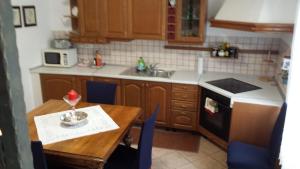 a kitchen with a table and a sink and a stove at moonflower in Pliskovica +16 photos