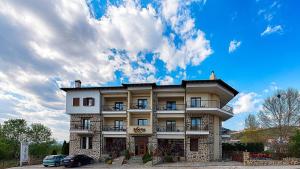 a large building with cars parked in front of it at Hotel Nostos in Kastoria