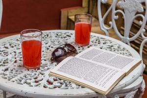 a table with two glasses and a book on it at Pousada Paraiso do Alto in Paraisópolis