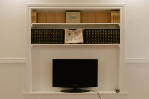 a tv sitting in a shelf in a room at Monroe Inn in Monroe