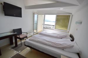 a bedroom with a bed and a desk and a television at Topencarov Guest House in Ohrid