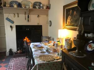 a dining room with a table and a fireplace at Church Street Homestay in Beaumaris