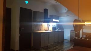 A kitchen or kitchenette at Sunrise Apartmanház