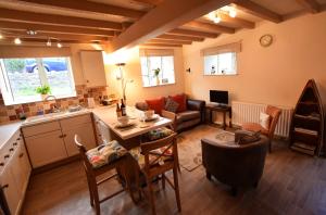 a kitchen and living room with a couch and a table at The Lodge in Masham