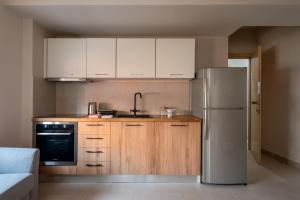 a kitchen with white cabinets and a refrigerator at 12 Keys Athens Apartments in Athens