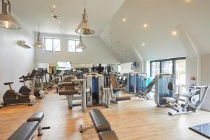 a gym with a lot of treadmills and machines at The Swan, Streatley, Berkshire in Streatley
