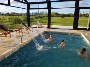 a group of people playing in a swimming pool at Iguape Aparts & Spa in Colón