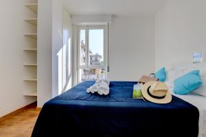 una camera da letto con un letto con un cappello sopra di My Peschiera Town Home a Peschiera del Garda