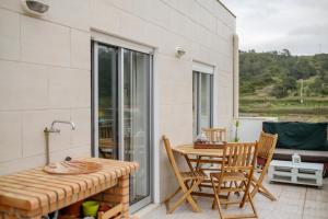 a patio with a table and chairs and a table at Rito´s Paradise in Nazaré