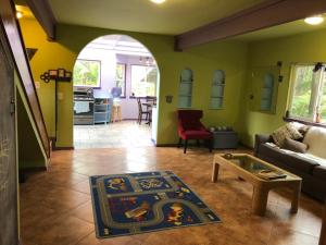 a living room with a couch and a table at Ixchel Hawaii Volcano in Volcano