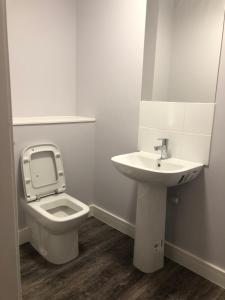 a bathroom with a toilet and a sink at Central Unite management Ltd in Manchester