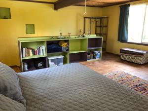 a bedroom with a bed and a book shelf at Ixchel Hawaii Volcano in Volcano