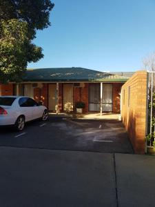 a white car parked in front of a building at Yambil Inn in Griffith