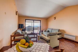 una sala de estar con una mesa con un bol de fruta en Villa Vistamar Lapcici en Budva