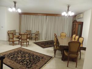 a dining room with a table and chairs at Sultan Cairo Nile Maadi in Cairo