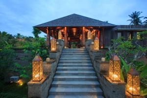 a staircase leading up to a house with lights at Tejaprana Bisma - CHSE Certified in Ubud