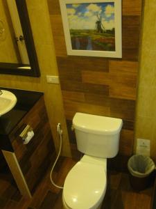 a bathroom with a white toilet and a sink at Villa Wanida Garden Resort in North Pattaya