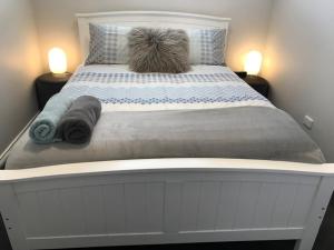 a large white bed with two pillows on it at Adelaide Hills Escape in Woodside