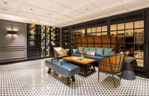 a living room with a couch and chairs and a table at La Siesta Premium Hang Be in Hanoi