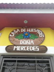 Ein Schild, auf dem Dana Mercede auf einem Gebäude steht. in der Unterkunft Hostal Doña Mercedes in Juayúa