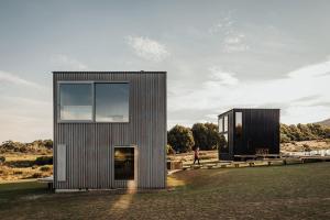 a house with a large window on the side of it at Seastacks at The Denison in Bicheno