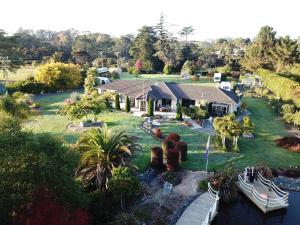 an aerial view of a house with a boat at Silverdale Garden Stay in Orewa