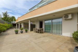 a patio with a table and chairs next to a building at Apartments Lux by Locap Group in Portorož