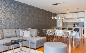 a living room with a couch and a table at Apartments Lux by Locap Group in Portorož
