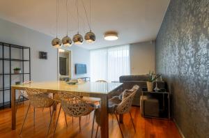 a dining room with a table and chairs at Apartments Lux by Locap Group in Portorož