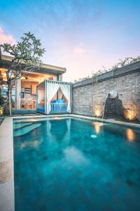 a swimming pool in the backyard of a house at IPIAN Jiwa by Pramana Villas in Ubud