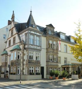 a large building with a flag in front of it at Hotel Detmolder Hof in Detmold