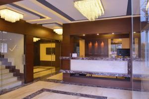 a lobby of a building with a reception counter at Hotel Royal Bengal in Bolpur