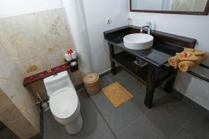 a bathroom with a white toilet and a sink at Martas Hotel in Gili Trawangan +36 photos