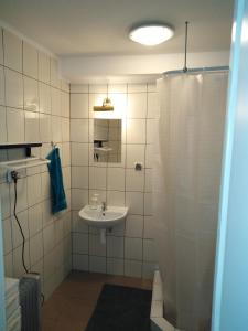a bathroom with a sink and a shower curtain at MORSKIE FALE in Kołobrzeg