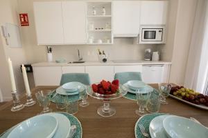 a kitchen with a table with a bowl of fruit on it at Gr Suites Boutique Catedral in Málaga