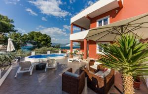 a house with a patio and a swimming pool at Holiday Villa Nostra in Trogir