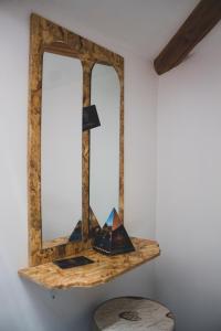 a shelf with a mirror on a wall at Grande borgo in Cava deʼ Tirreni