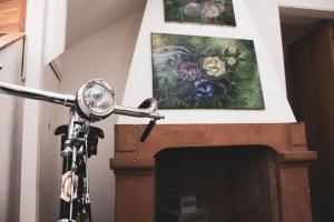 a motorcycle parked next to a fireplace with a painting at Grande borgo in Cava deʼ Tirreni