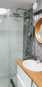 a bathroom with a sink and a shower at Gaia Studio in Wrocław +7 photos
