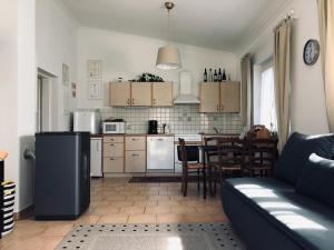 a kitchen and living room with a couch and a table at Ferienhaus Villach in Villach