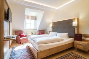 Łóżko lub łóżka w pokoju w obiekcie Hotel-Restaurant Kirchenwirt
