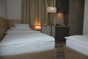a hotel room with two beds and a lamp at Hotel Fiesa in Piran +37 photos