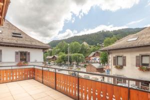 a balcony with a view of the mountains at PLACE EGLISE 2 in Morzine +8 photos