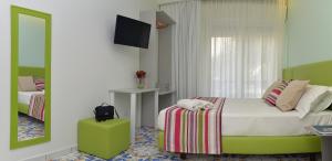 a bedroom with a bed and a mirror at San Domenico Accommodation Maiori in Maiori