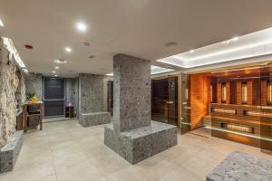 a lobby with stone pillars in a building at Hotel Malin in Malinska +140 photos