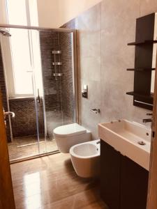 a bathroom with a toilet and a sink and a shower at Cinqueterre Manarola in La Spezia